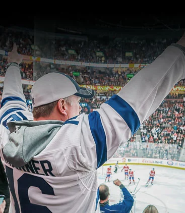 A hockey fan cheering at an arena