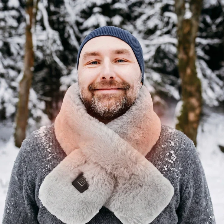 A man wearing the Solana Gear Heated Scarf in the snow