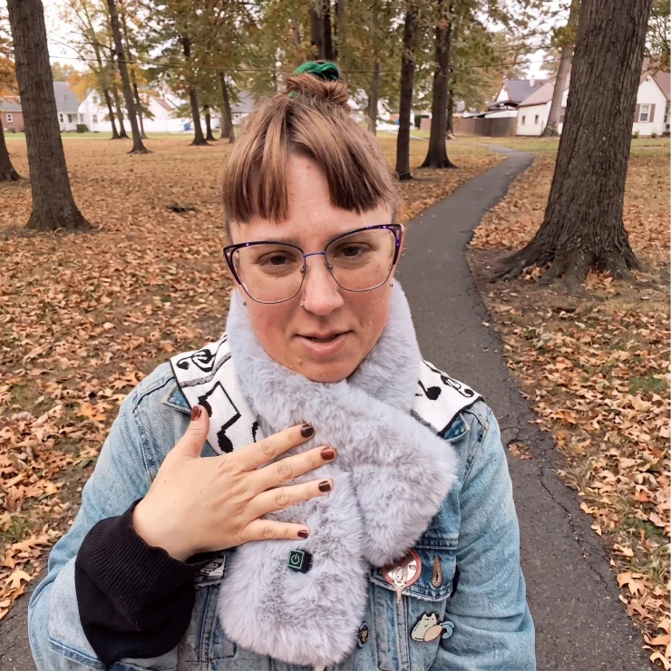 A woman wearing the heated scarf in a park in autumn